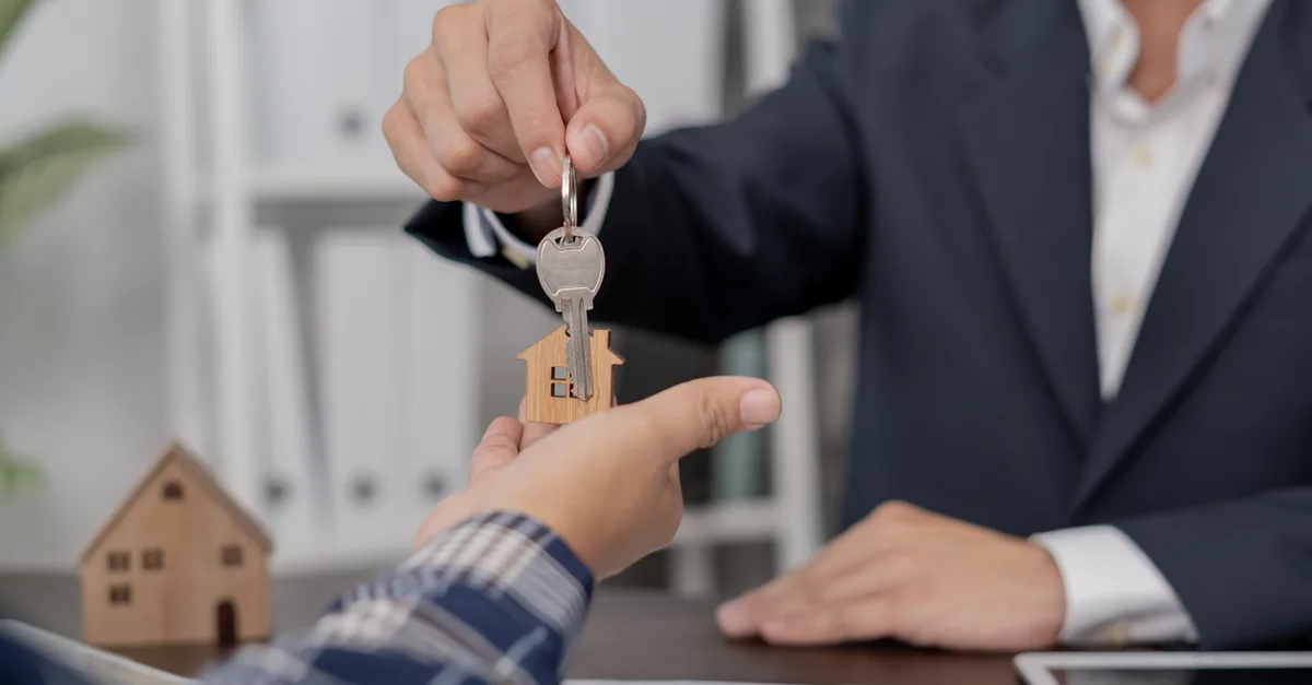 Real estate agent handing house keys to a new owner