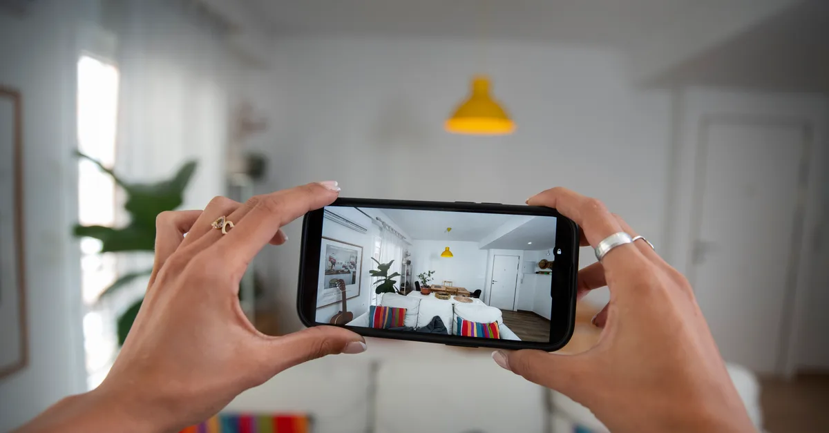 Photographing a bright living room with a phone held in both hands