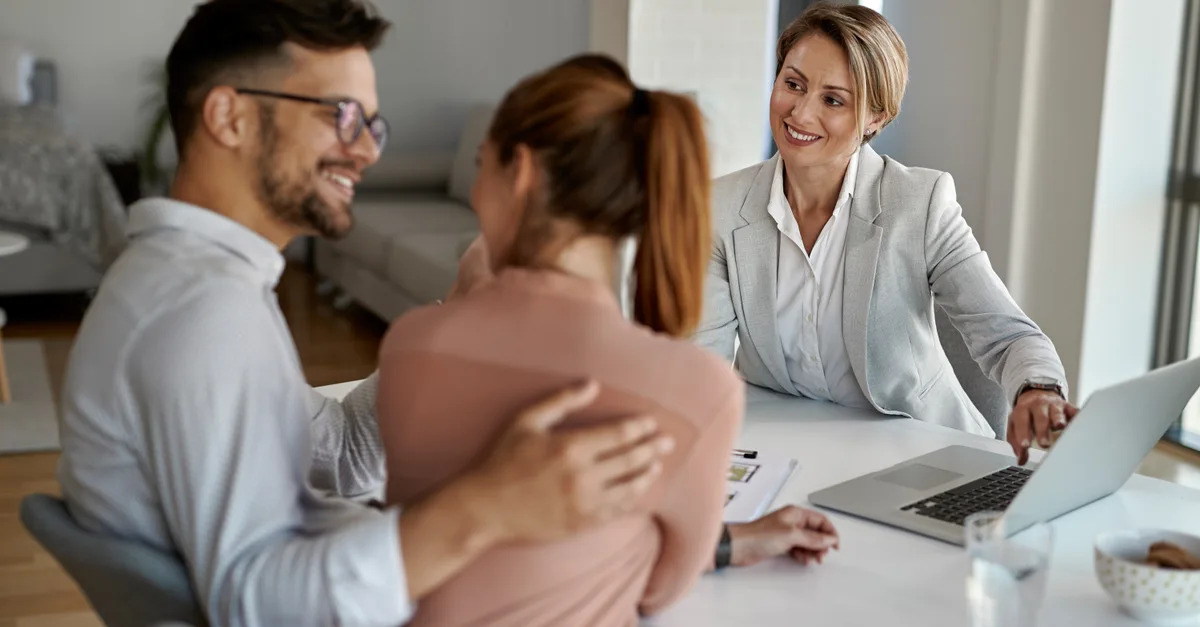 Real estate agent advising a couple about selling their house